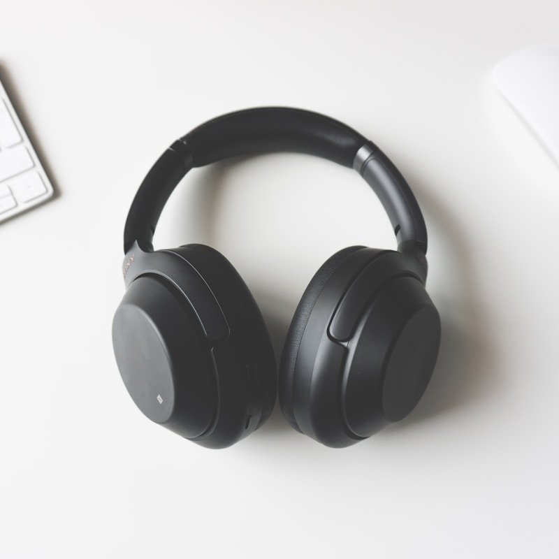 High-end wireless headphones and audio setup on minimalist podium